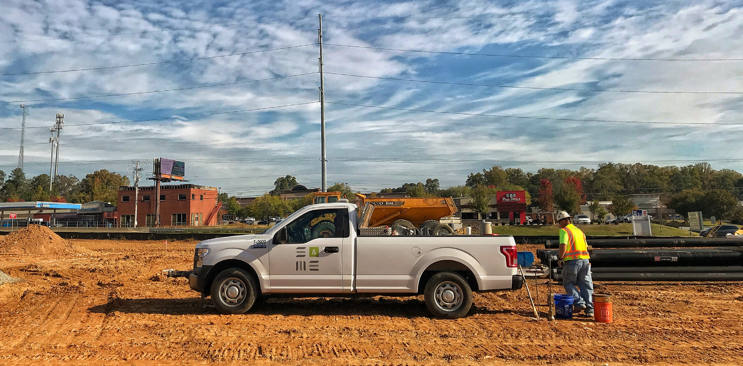 Fleet vehicle on jobsite with worker in PPE