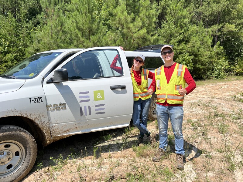 Technicians in high vis vests with fleet vehicle